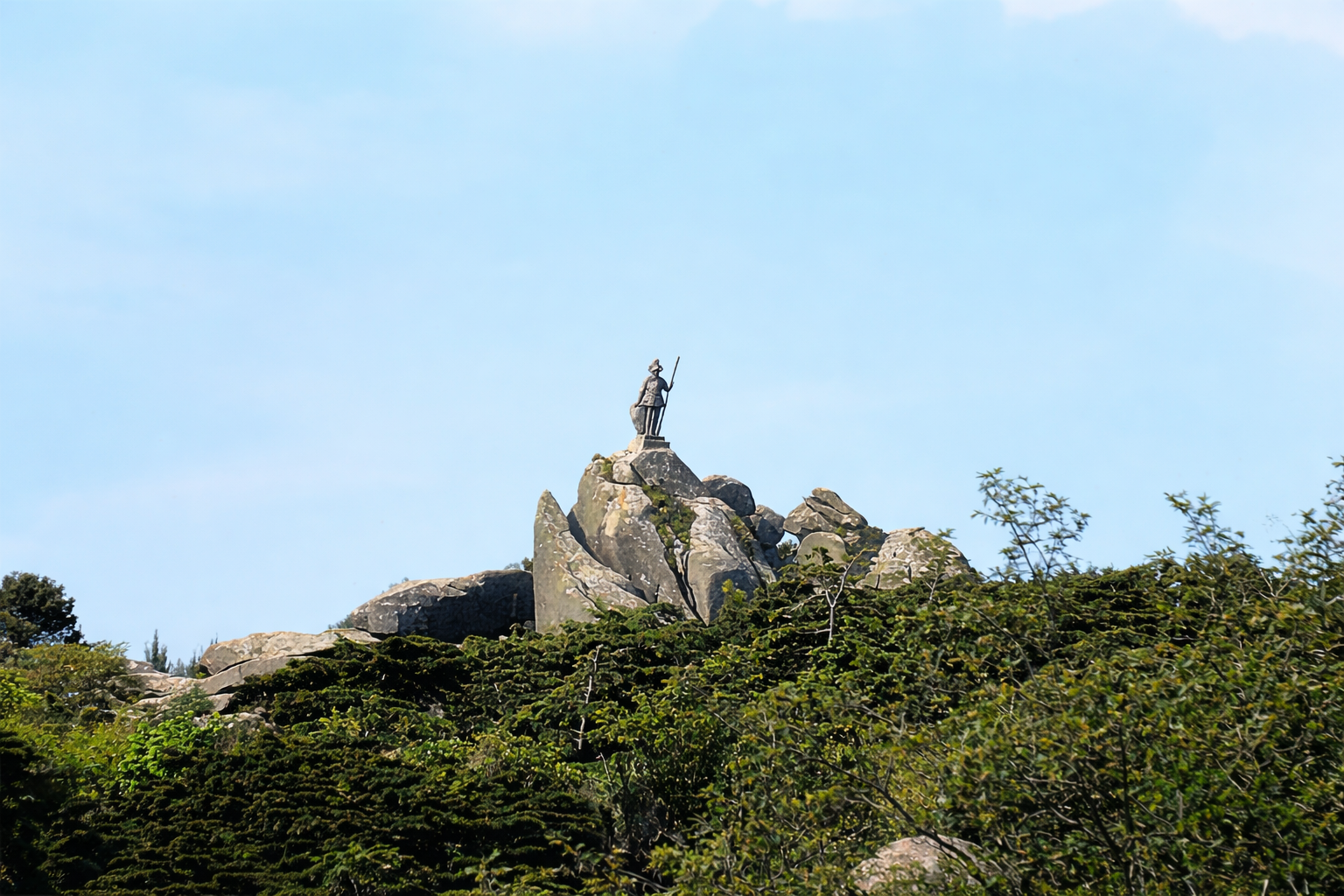 Estátua imponente no topo das rochas