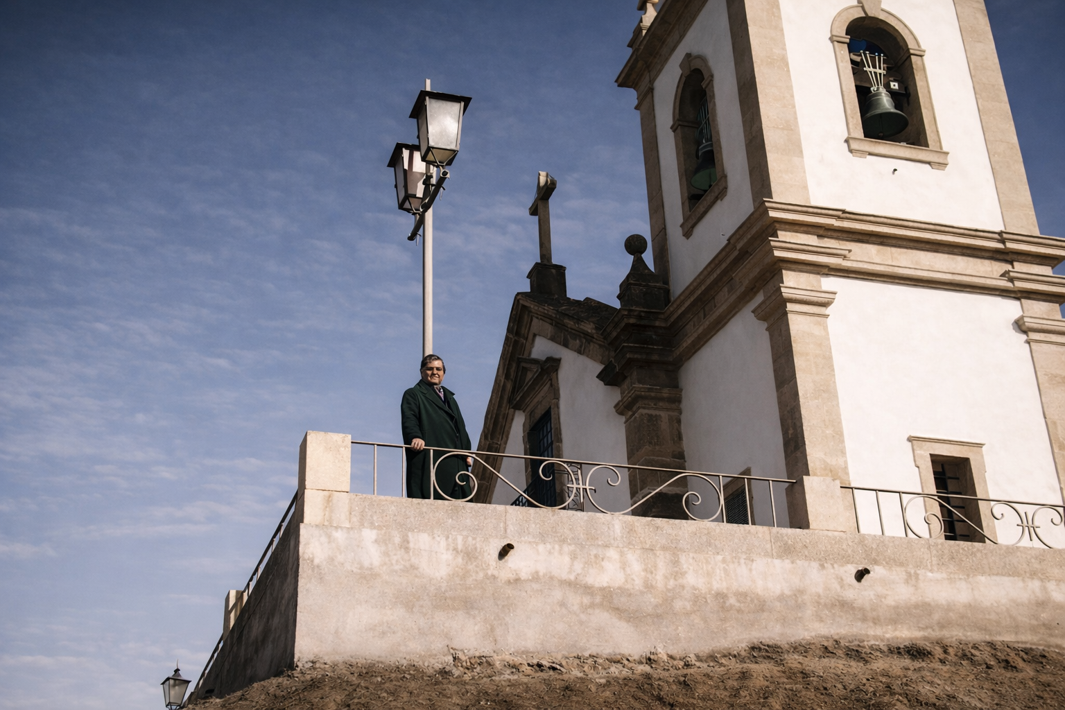 Homem na varanda com vista para igreja