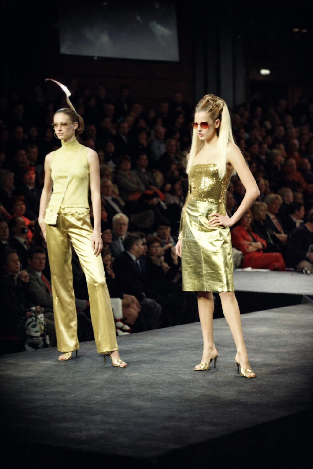 Desfile de moda dourado no palco