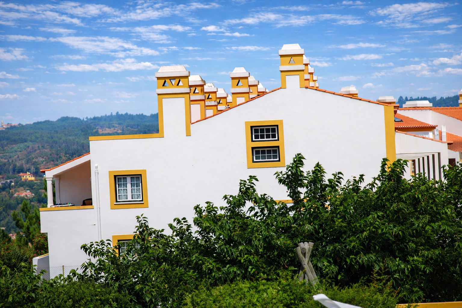 Casas mediterrânicas em colina verdejante